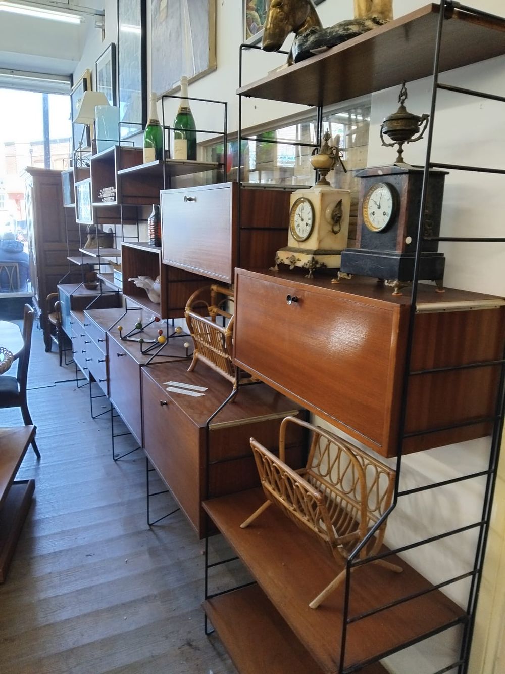 Lot 179 – A large 6 bay mid-century modular teak and steel shelving system attributed to Staples Ladderax