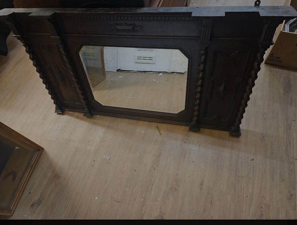 Lot 218 – An early 20th-century Jacobean Revival oak overmantel mirror retailed by Jones and Higgins Ltd