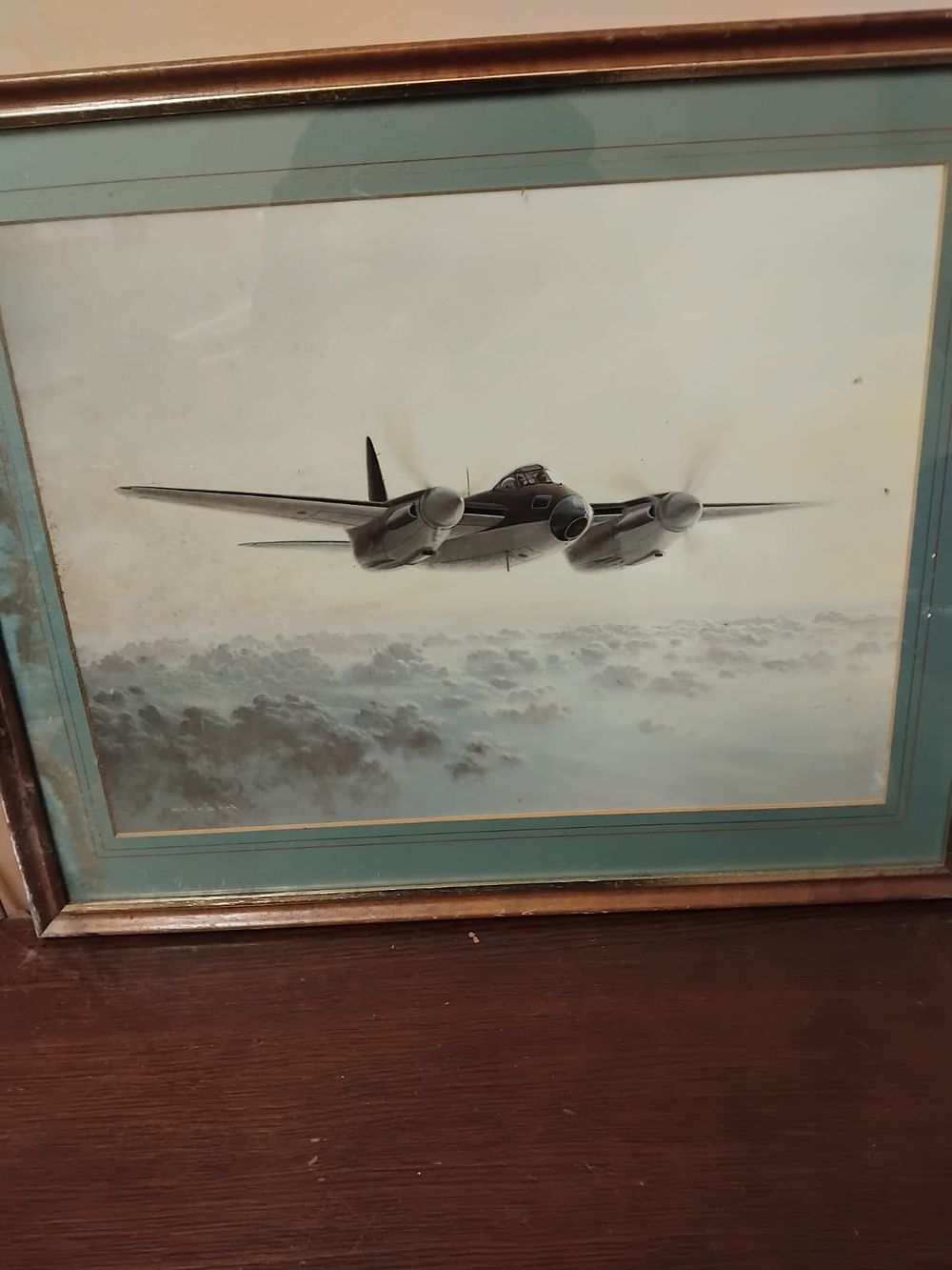 Lot 228 – Aviation Interest: A Framed Print of a de Havilland Mosquito in Flight, in the style of Gerald Coulson (Signed)