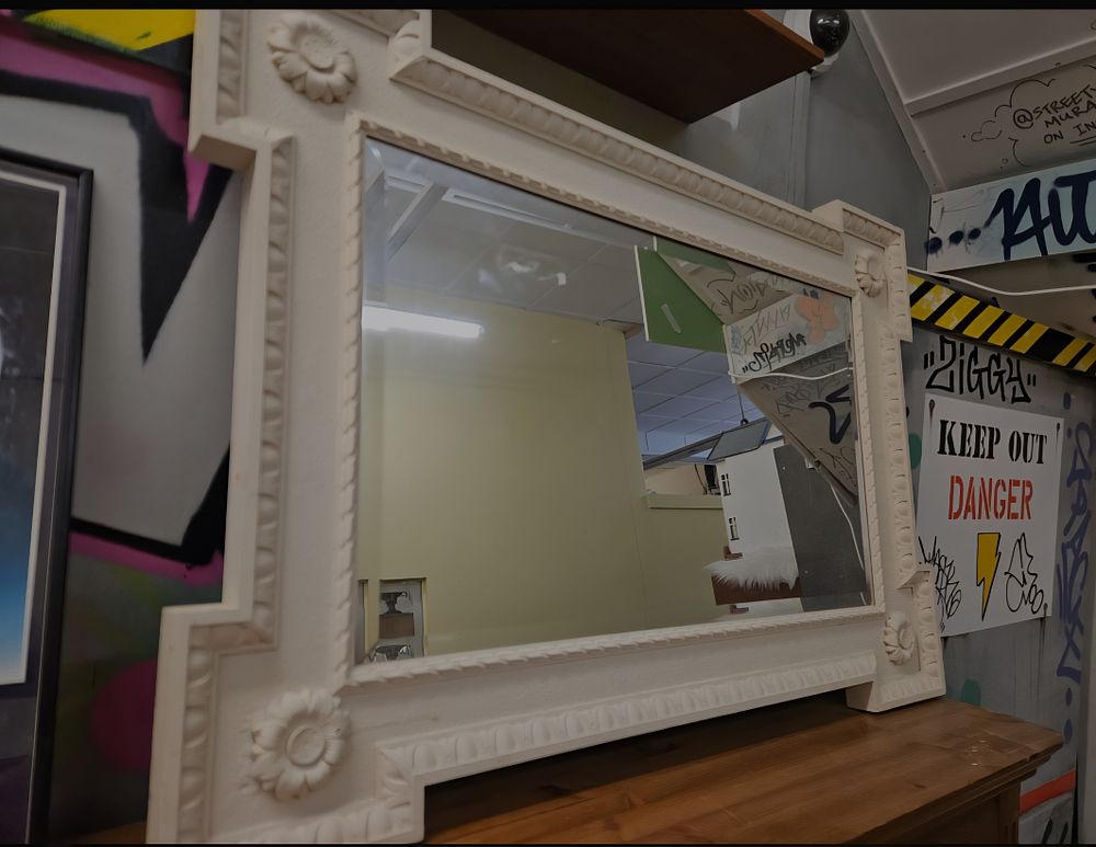 Lot 248 – A 20th-century Neoclassical style cream-painted eared wall mirror