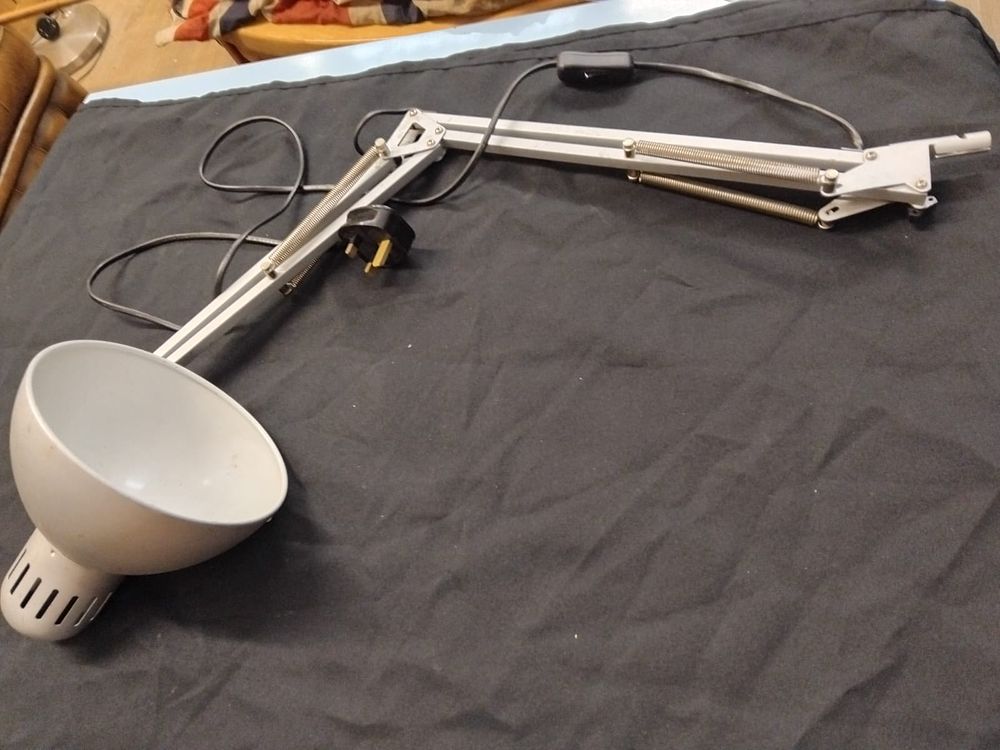 Lot 293 – An adjustable articulated light grey metal work lamp
