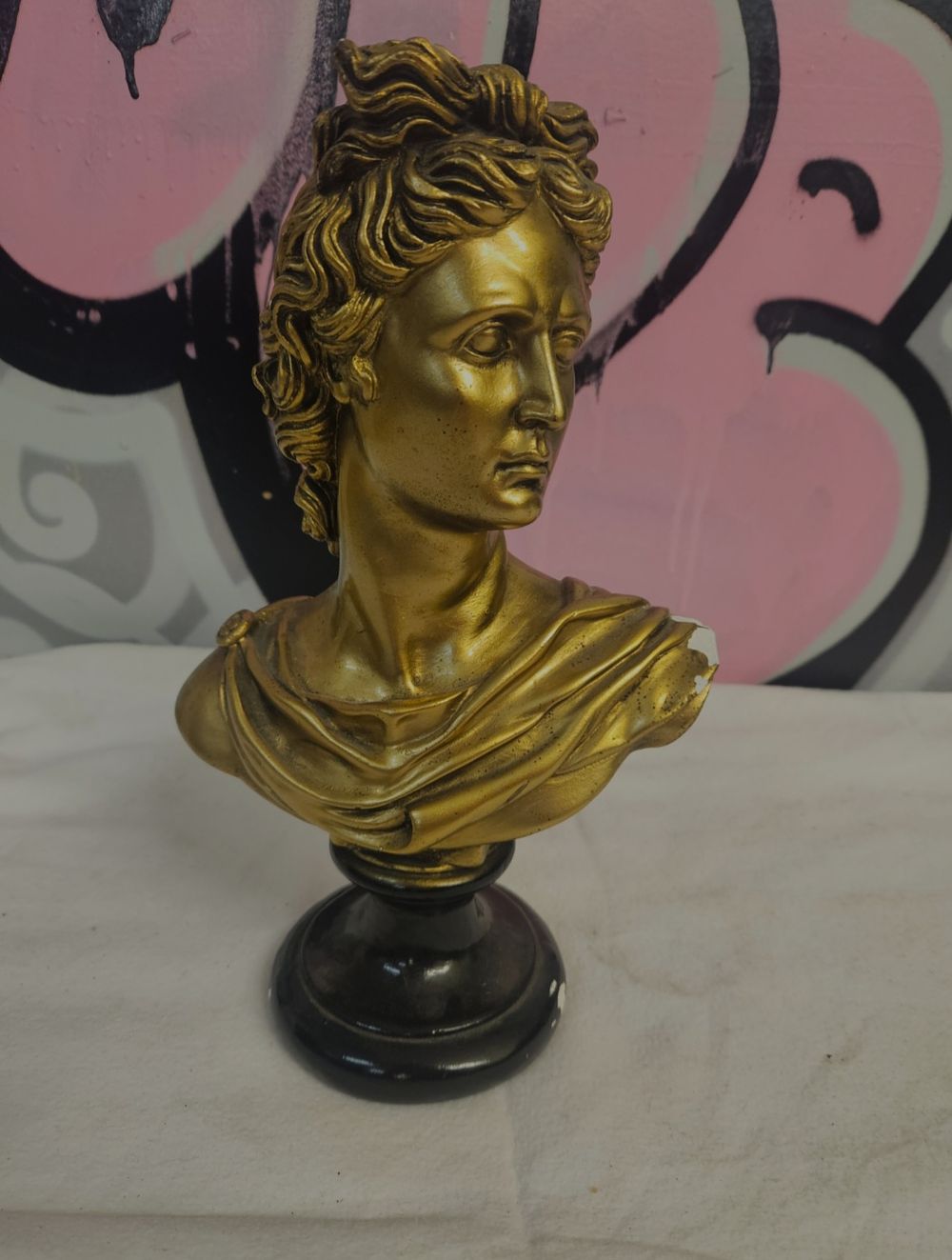 Lot 319 – A neoclassical style gold-coloured composition bust of Apollo