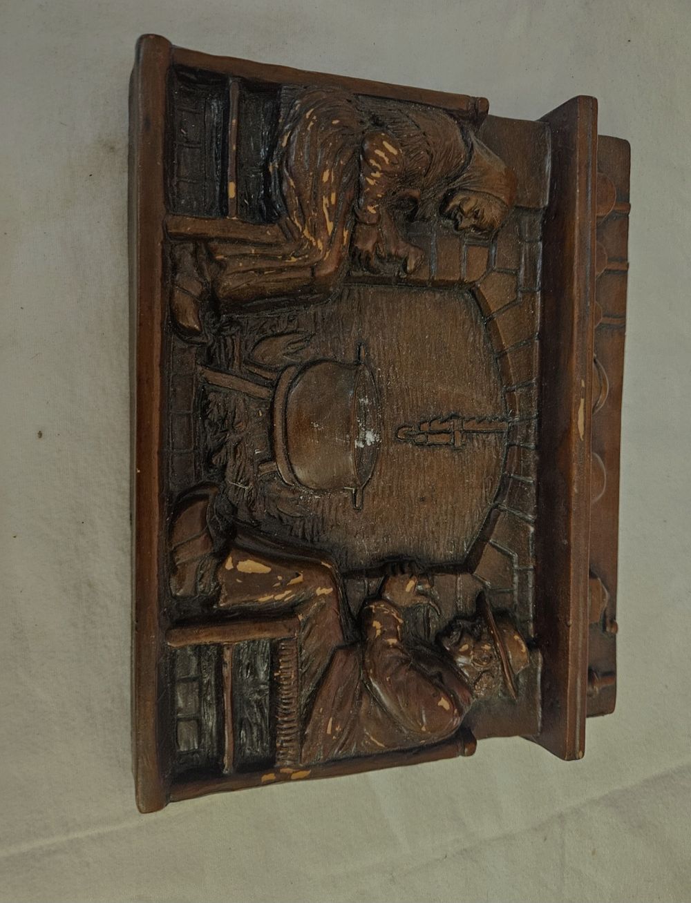 Lot 406 – A high-relief moulded composition wall plaque depicting a rustic kitchen scene