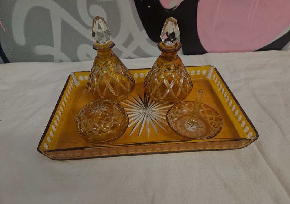 Lot 413 – A five-piece Art Deco style amber and clear cut glass vanity set