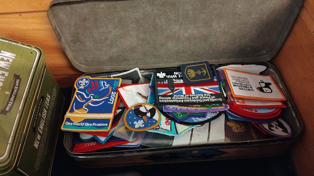 Lot 427 – A Collection of United Kingdom Scouting and Girl Guiding Commemorative and Unit Cloth Badges in a Metal Tin