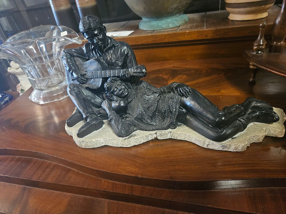 Lot 300j – A contemporary cold-cast figurative sculpture of a guitarist and reclining companion