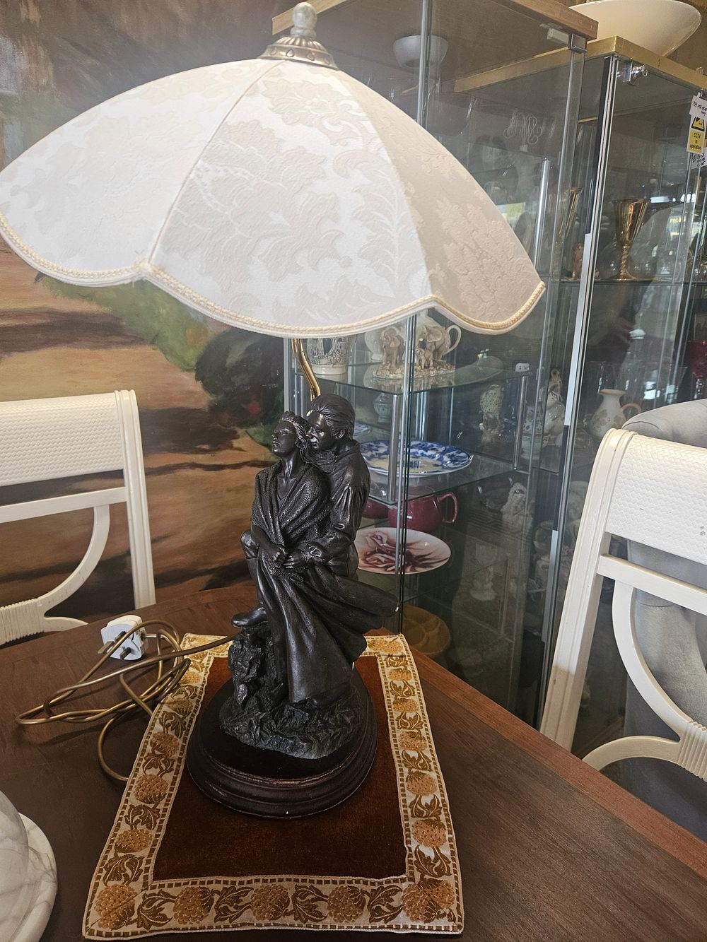 Lot 300w – A Decorative Bronzed Figural Table Lamp with Scalloped Fabric Shade