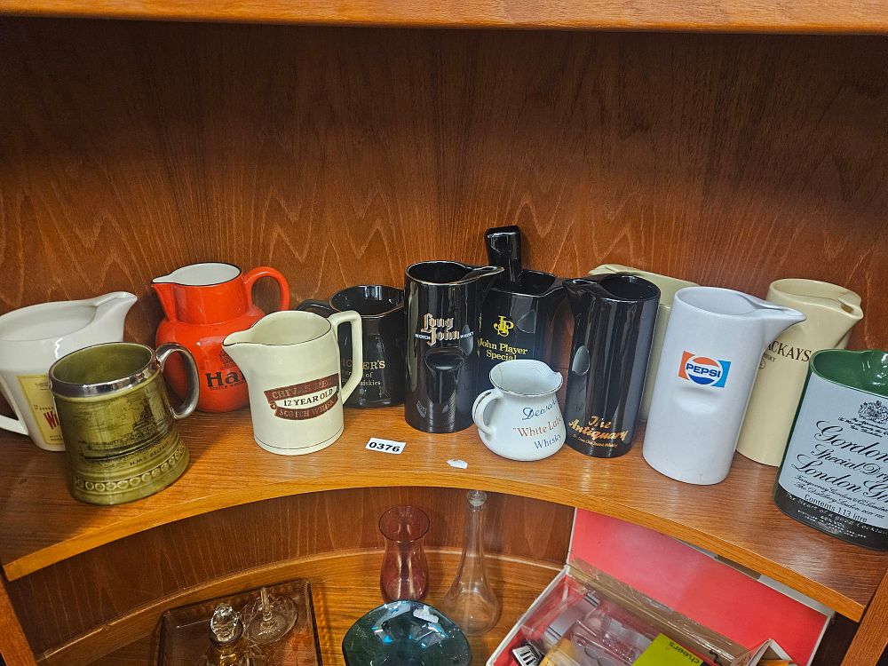 Lot 376 – An Assortment of Thirteen Vintage Ceramic Advertising  Jugs and Barware