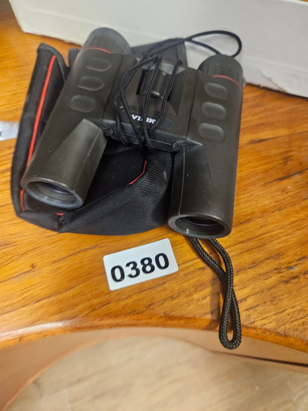 Lot 380 – A pair of compact rubber-armoured binoculars with carrying case