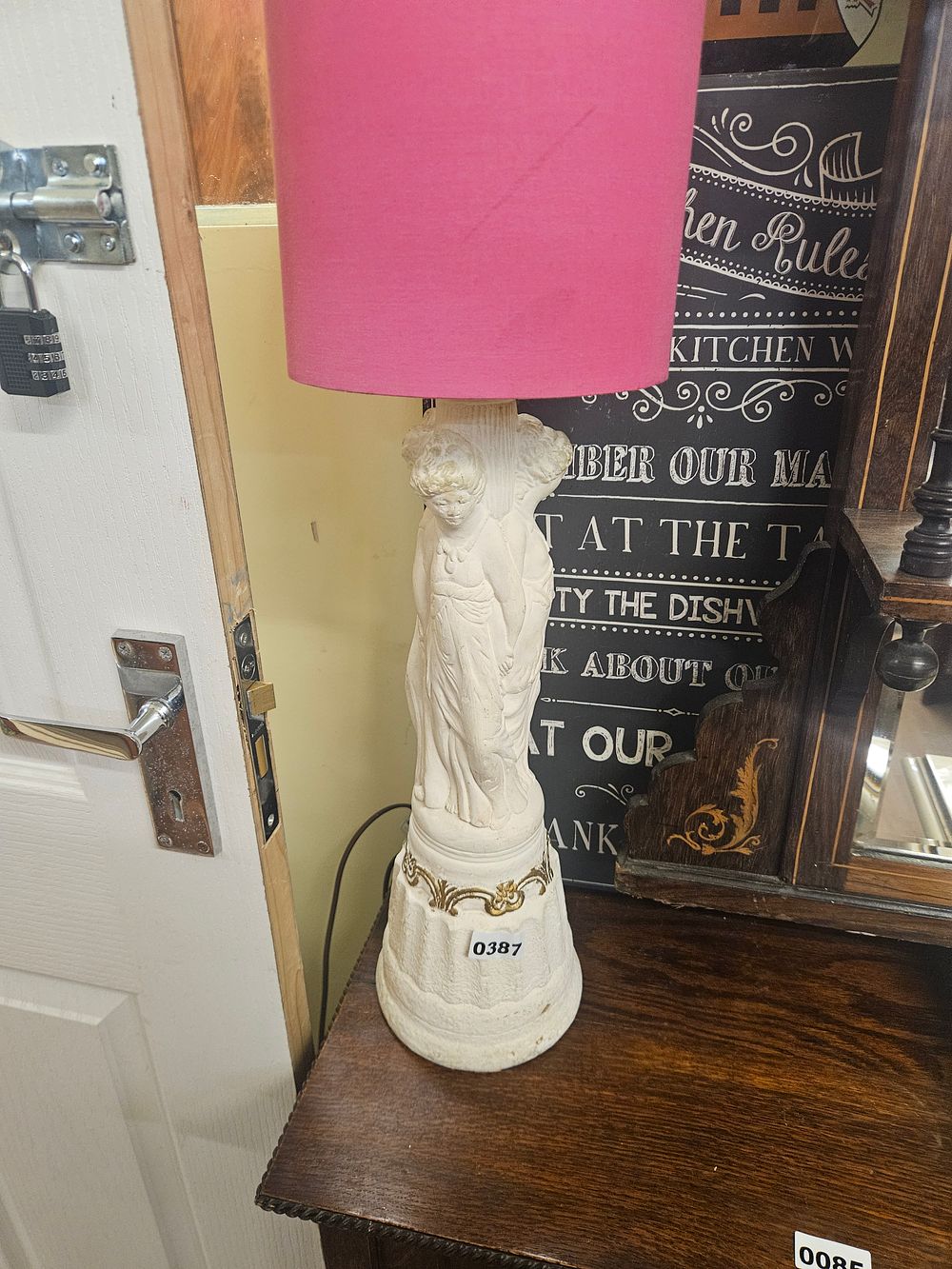 Lot 387 – A Neoclassical Style Figural Table Lamp with Pink Drum Shade