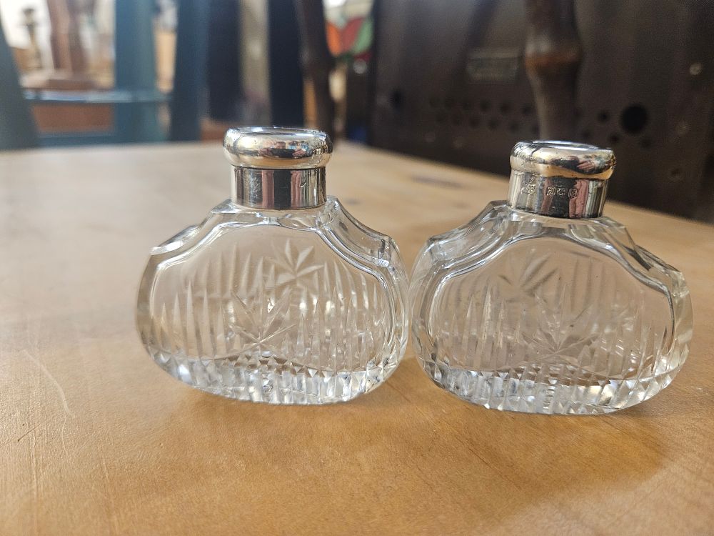 Lot 397 – A Pair of George V Sterling Silver-Mounted Cut Glass Dressing Table Bottles, Robert Pringle and Sons, Birmingham, 1918