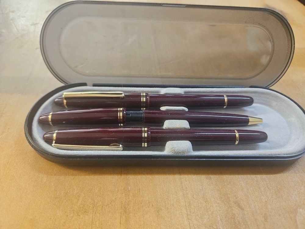 Lot 402 – An Assortment of Writing Instruments comprising a Burgundy Three-Piece Set, a Guinness Promotional Pen Collection, and a USB Flash Drive Pen