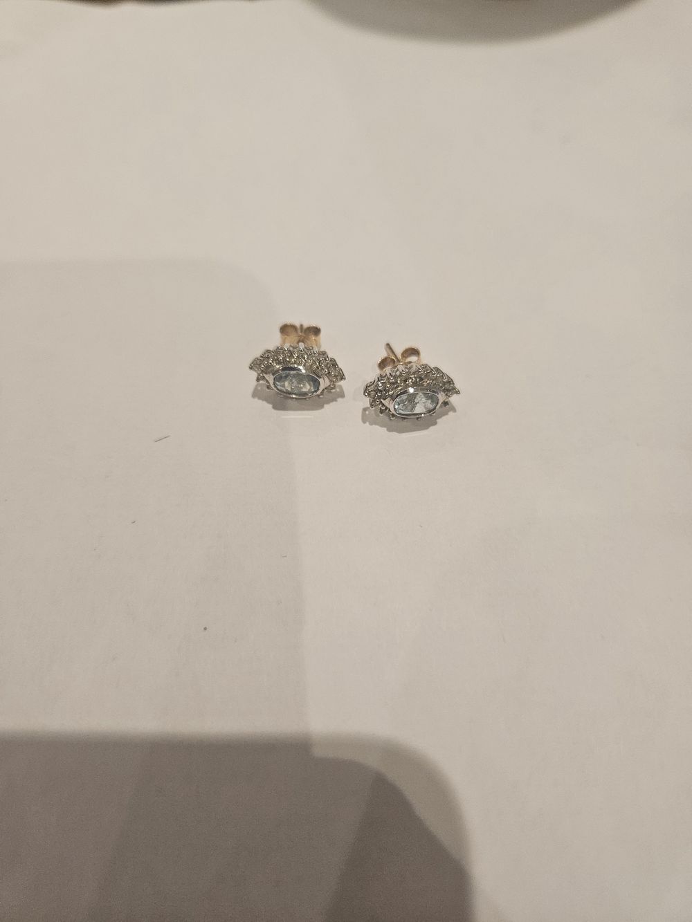Lot 439 – A Pair of 9ct gold Oval Blue Gemstone and Colourless Stone Cluster Stud Earrings 2.5grams