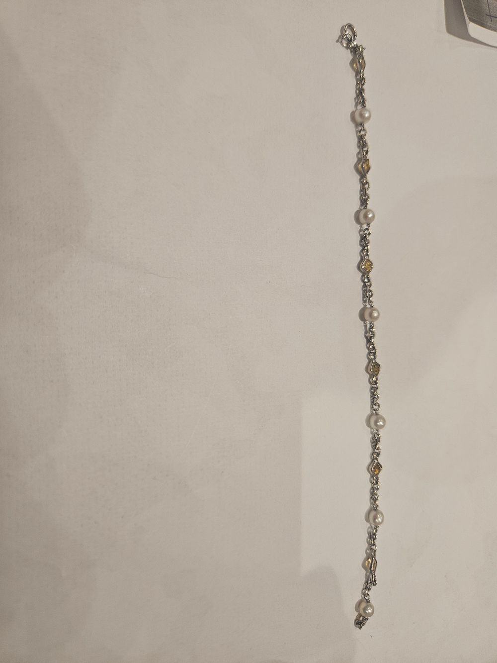 Lot 448 – A 18ct white gold, Pearl, and Yellow Gemstone Station Bracelet 3.7grams