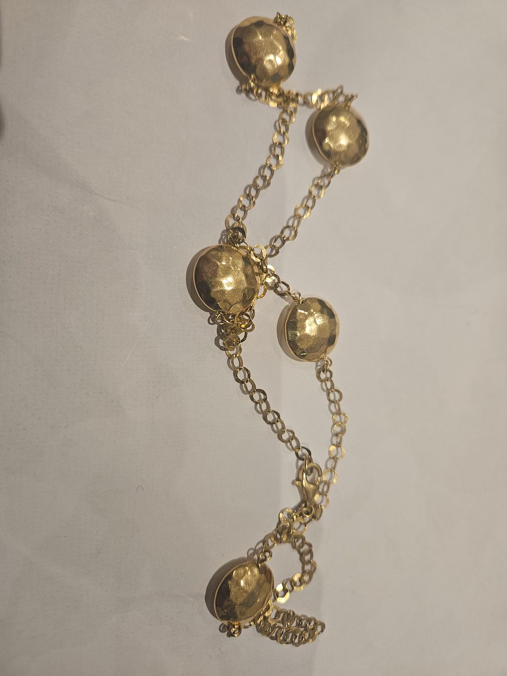 Lot 453 – A silver gift  bracelet with hammered circular stations