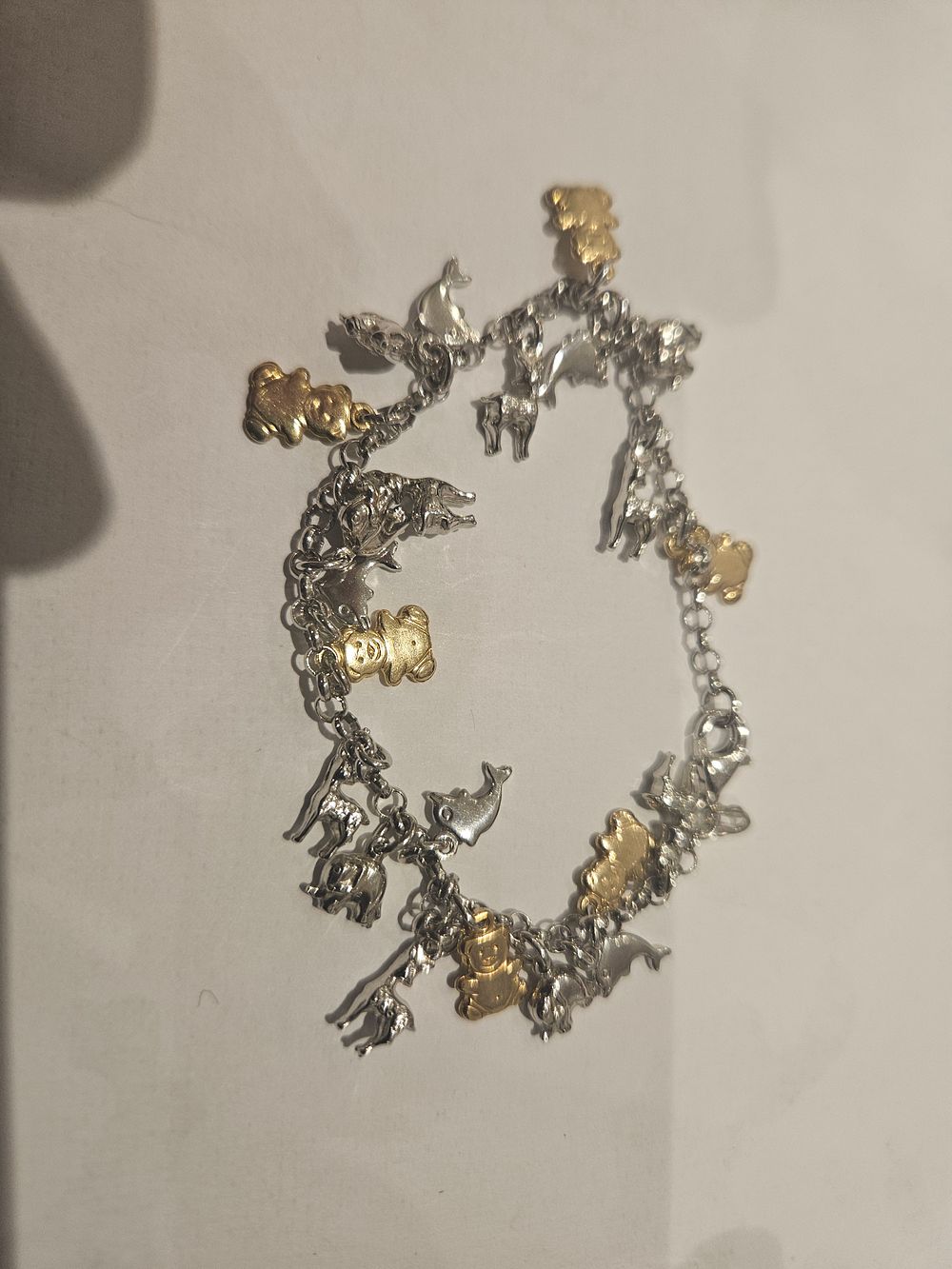 Lot 454 – A silver Animal-Themed Two-Tone Charm Bracelet 13.8grams