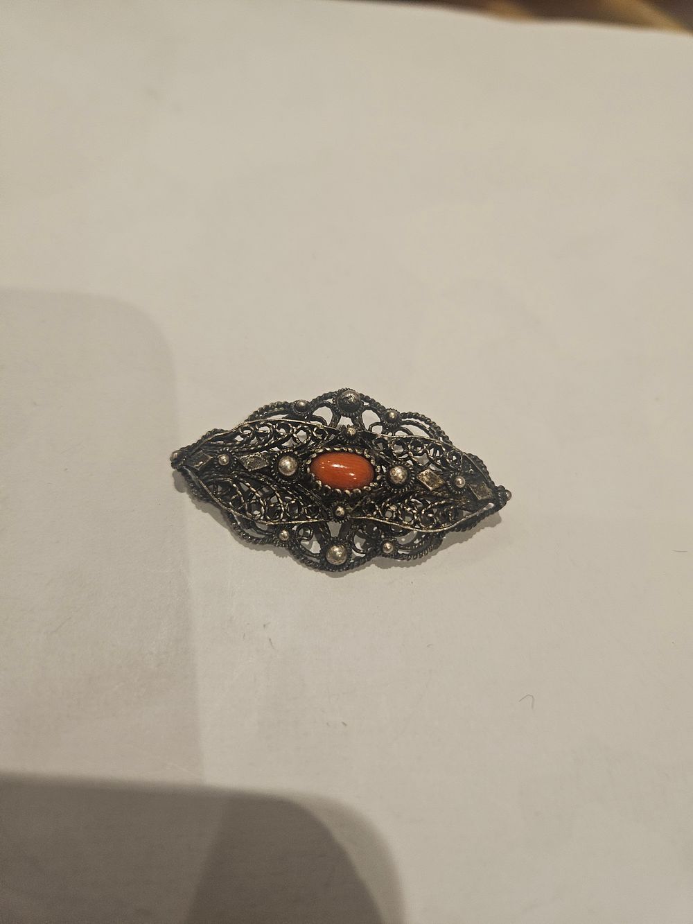 Lot 458 – An antique Silver Filigree and Coral Brooch