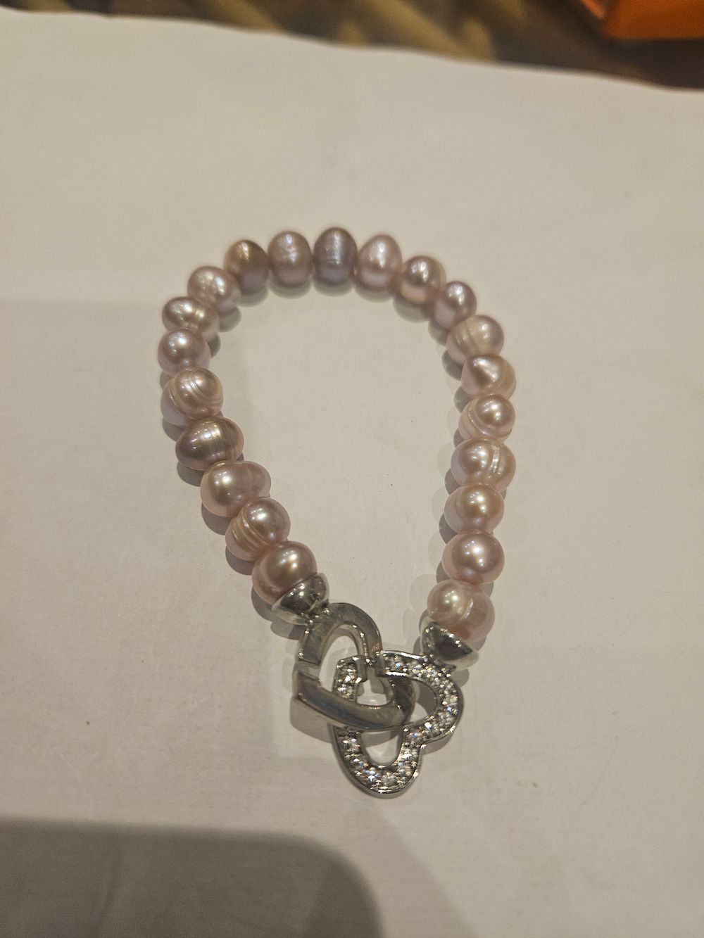 Lot 459 – A Cultured Freshwater Pearl Bracelet with Interlocking silver Heart Clasp