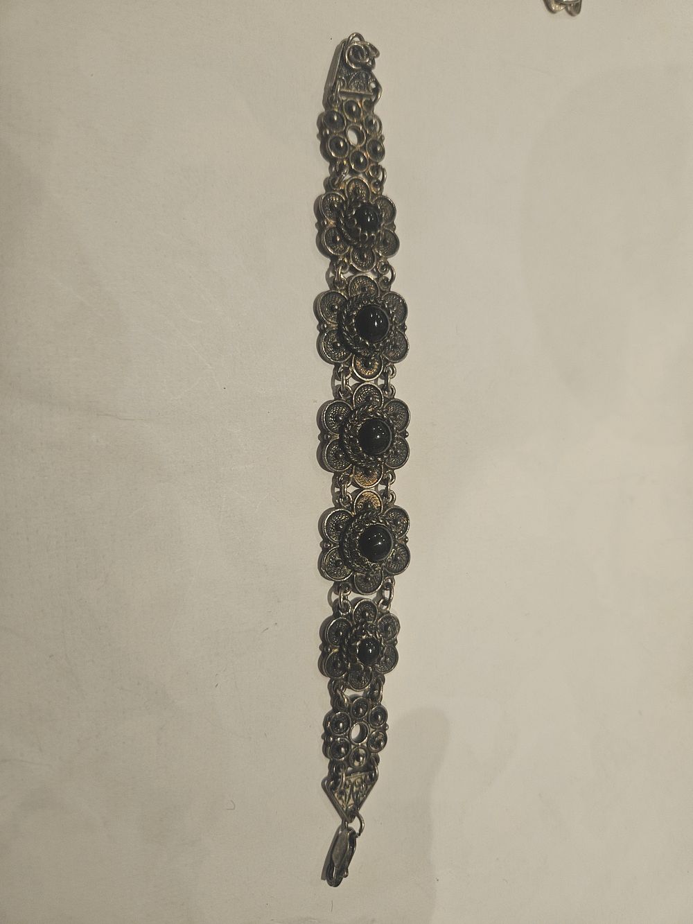Lot 460 – Vintage Silver Filigree Floral Panel Bracelet with Black Cabochons 23.9grams