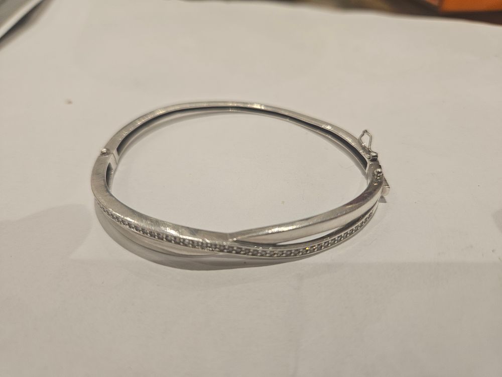 Lot 462 – A Silver Hinged Crossover Bangle Set with Clear Stones 10.3grams