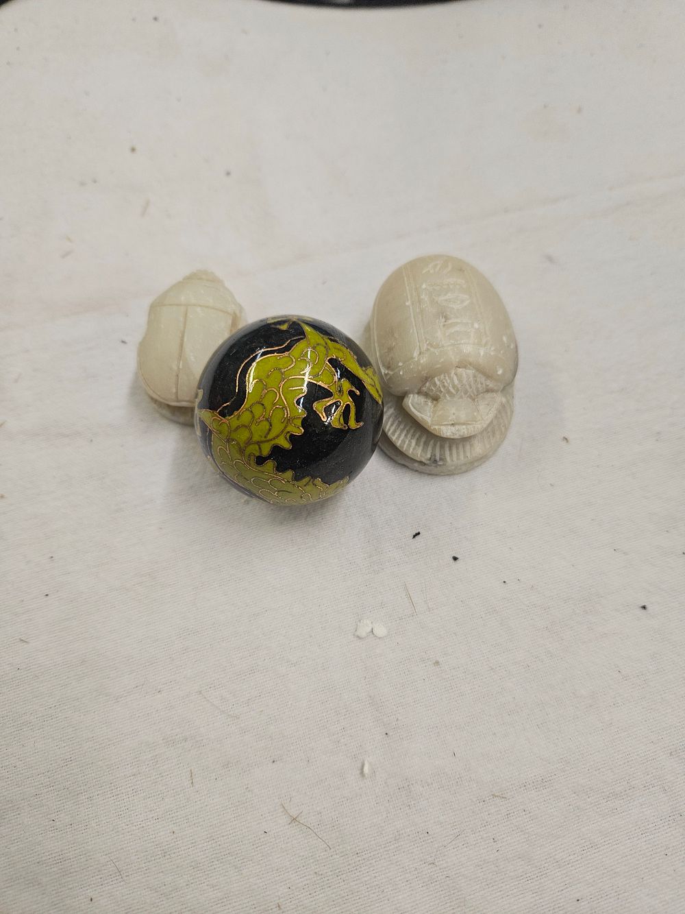 Lot 186 – A Trio of Decorative Objects Comprising Two Carved Stone Scarabs and a Cloisonné Enamel Sphere