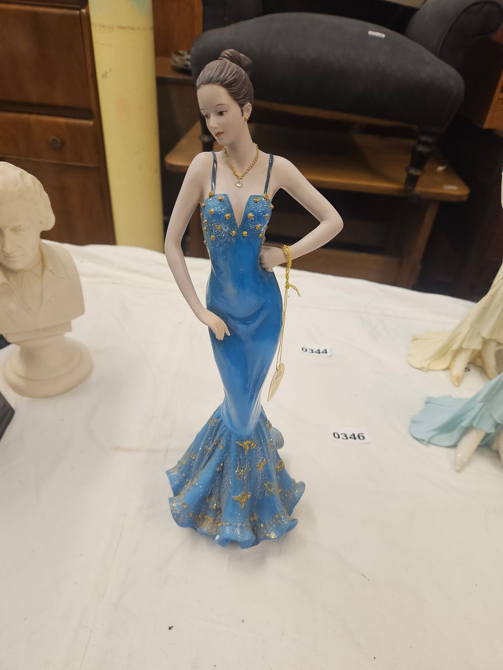 Lot 210 – A Modern Porcelain Figurine of a Lady in a Midnight Blue and Gold Evening Gown