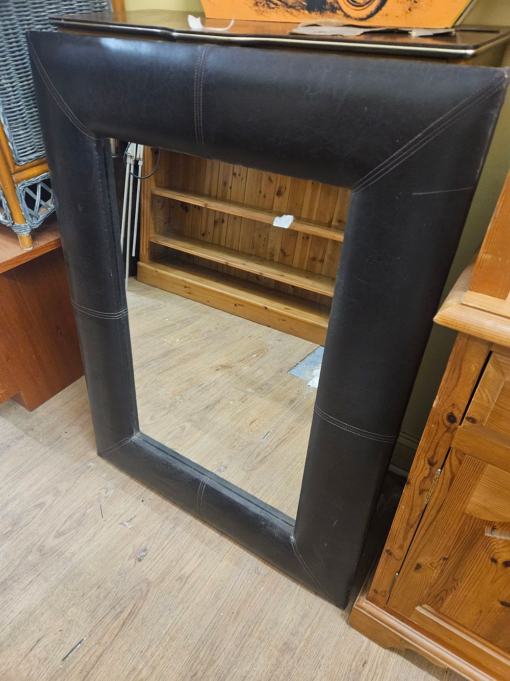 Lot 238 – A contemporary rectangular wall mirror with dark brown upholstered faux leather frame