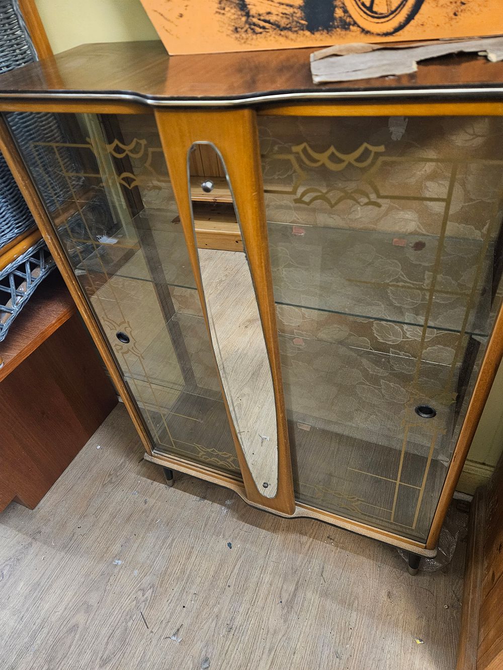 Lot 239 – A Mid-Century Teak-Veneered Display Cabinet with Patterned Glass Sliding Doors