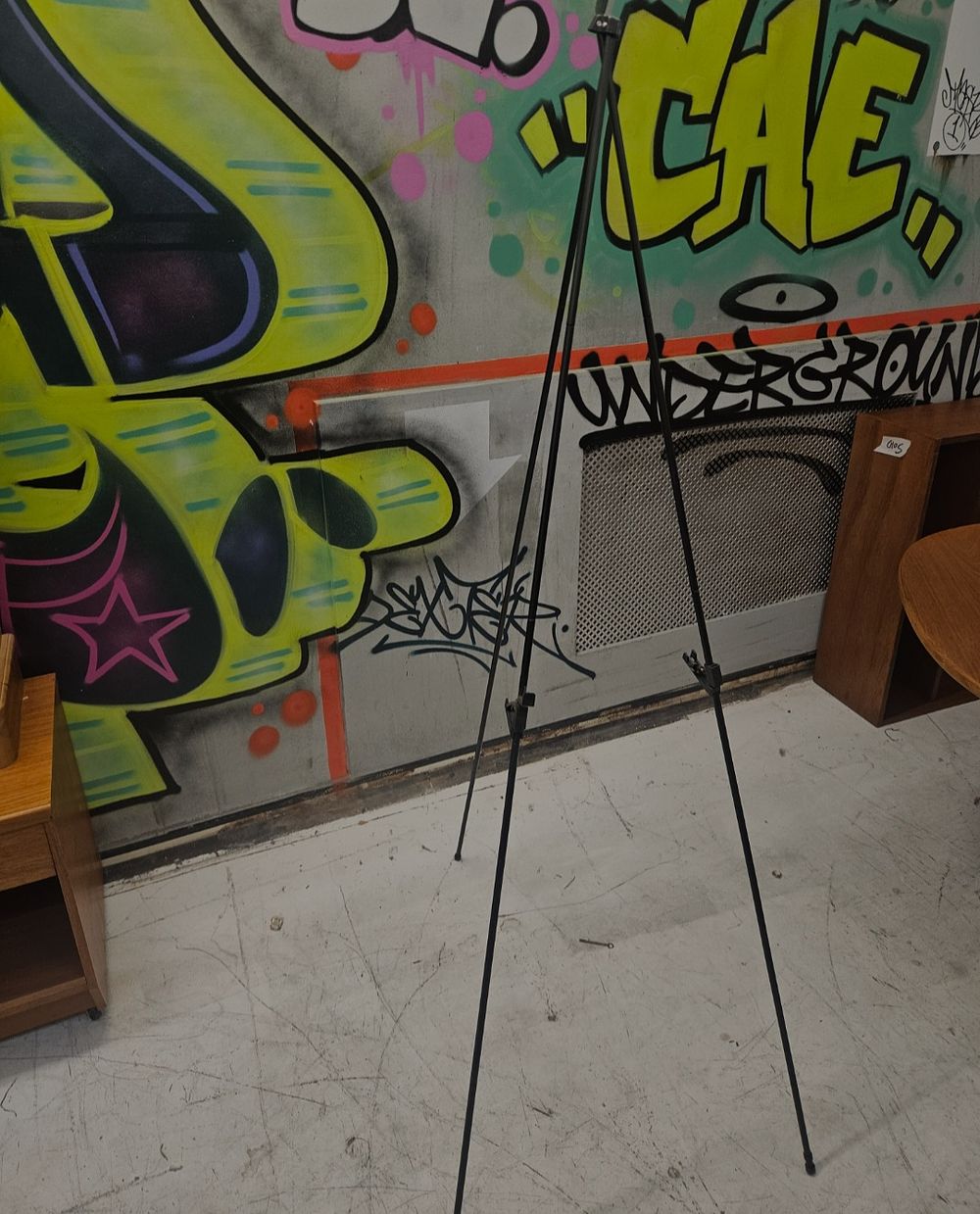 Lot 308 – A Portable Black Metal Tripod Display Easel