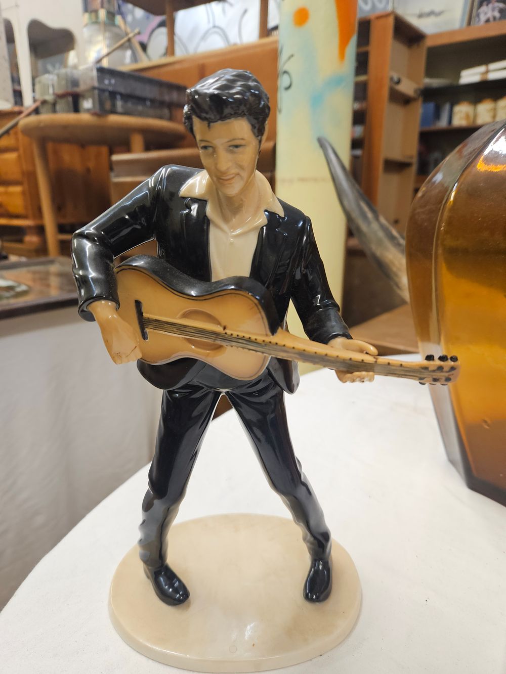 Lot 150 – A glazed ceramic figurine of Elvis Presley with a guitar