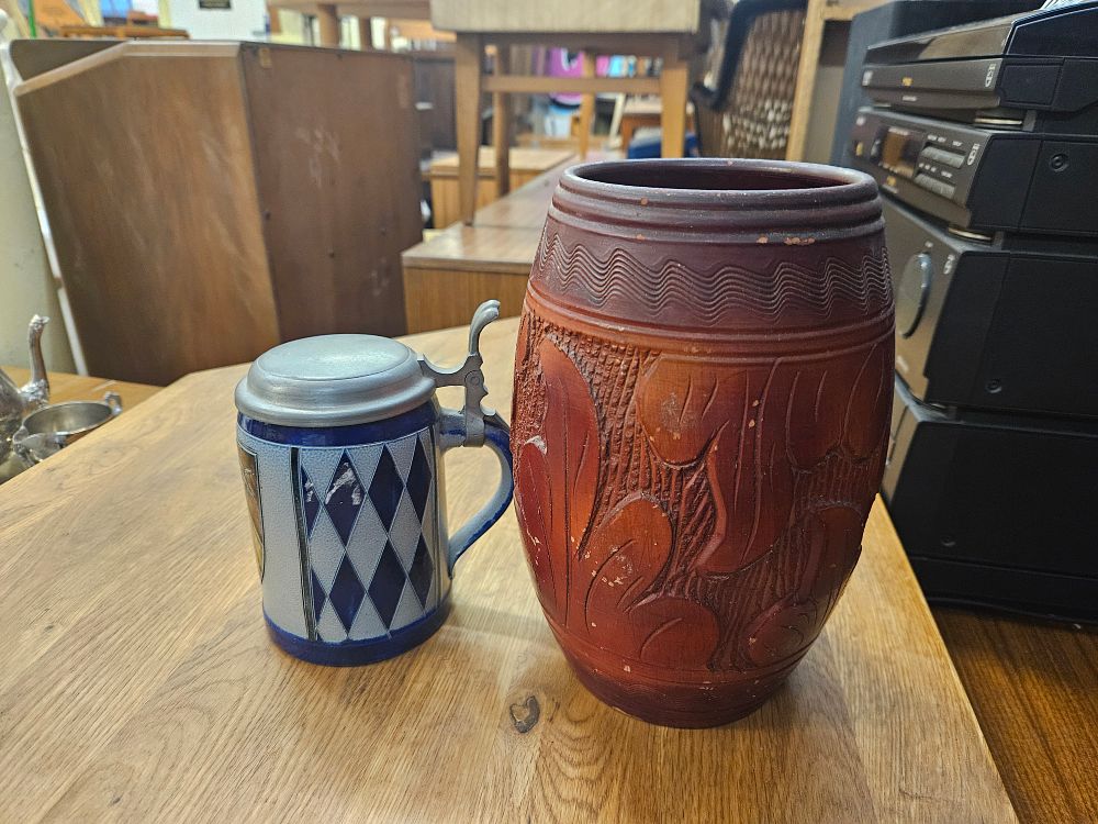 Lot 172 – A Trio of Decorative Items Including a German Salt-Glazed Stoneware Stein, a Large Relief-Carved Ceramic Jar, and a Pewter Lidded Tankard