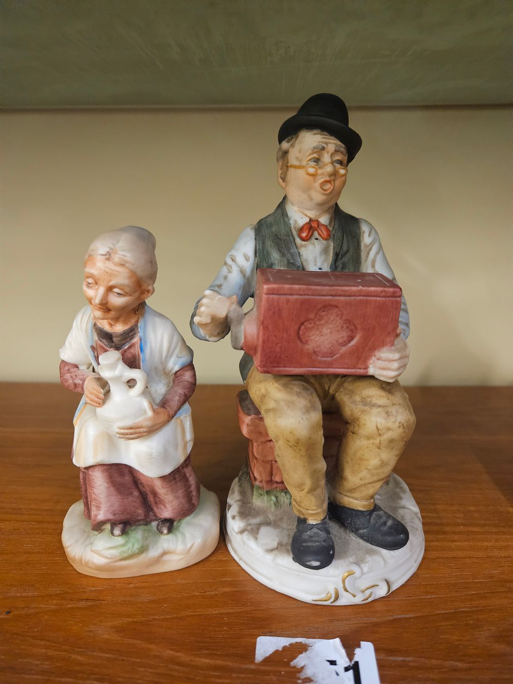 Lot 175 – A Pair of Hand-Painted Bisque Ceramic Figurines Depicting an Elderly Couple