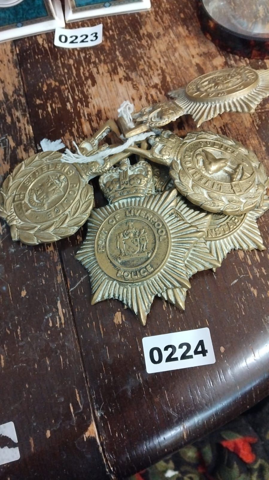 Lot 224 – A Group of Five Early to Mid-20th Century Brass British Police Helmet Plates