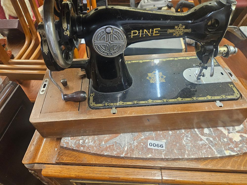 Lot 255 – A pine Sewing Machine Co. Hand-Crank Sewing Machine