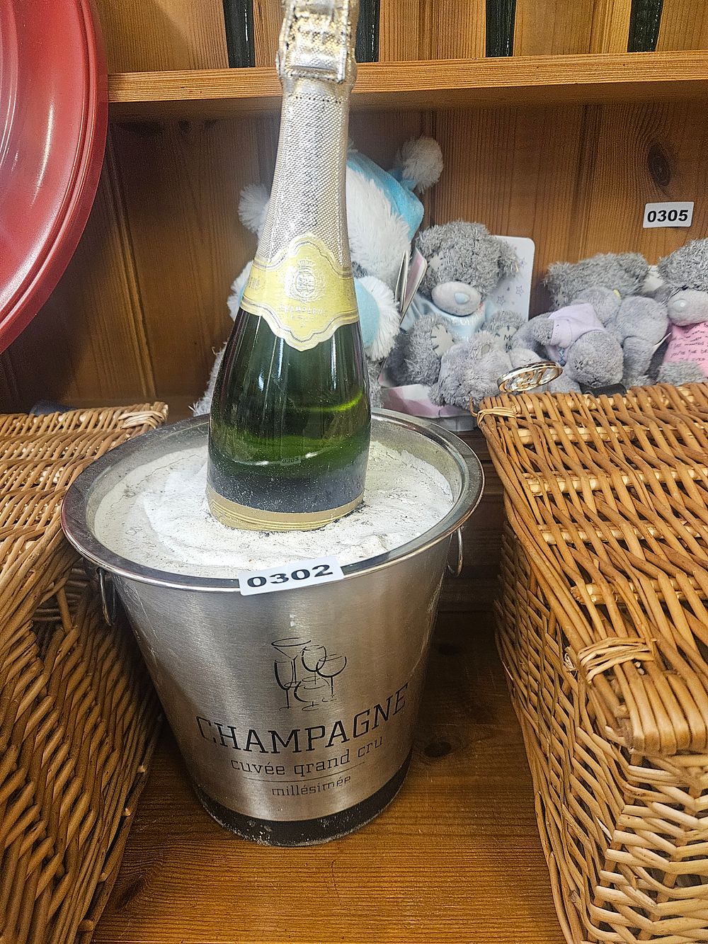 Lot 302 – A Polished Metal Champagne Ice Bucket and Bottle of Champagne