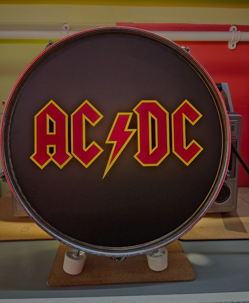 Lot 150d – AC/DC Themed Decorative Drum Head Display on Wooden Stand
