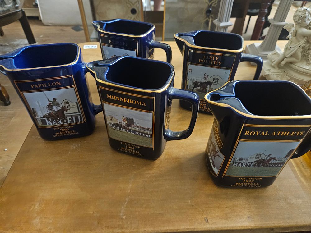 Lot 160 – Five Martell Cognac Grand National Winner Commemorative Ceramic Water Jugs