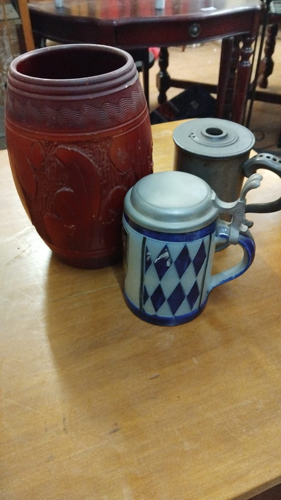 Lot 178 – A trio of assorted vessels including a Bavarian pattern salt-glazed stoneware beer krug, a lidded metal tankard, and a large relief-molded earthenware jar