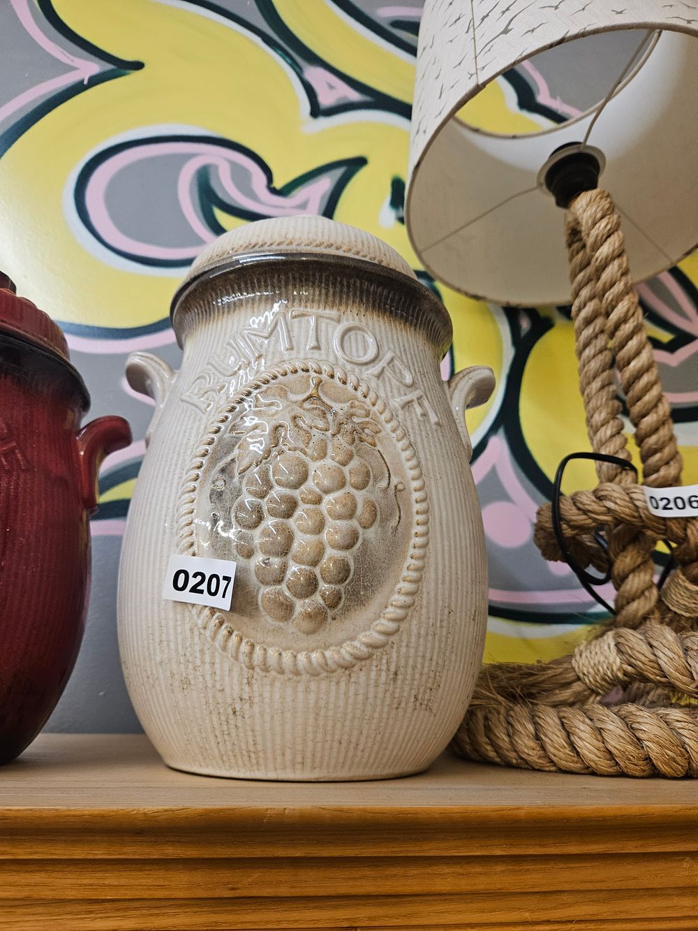 Lot 207 – An Italian Relief-Molded Earthenware Storage Jar with Grape Motif and Inscription
