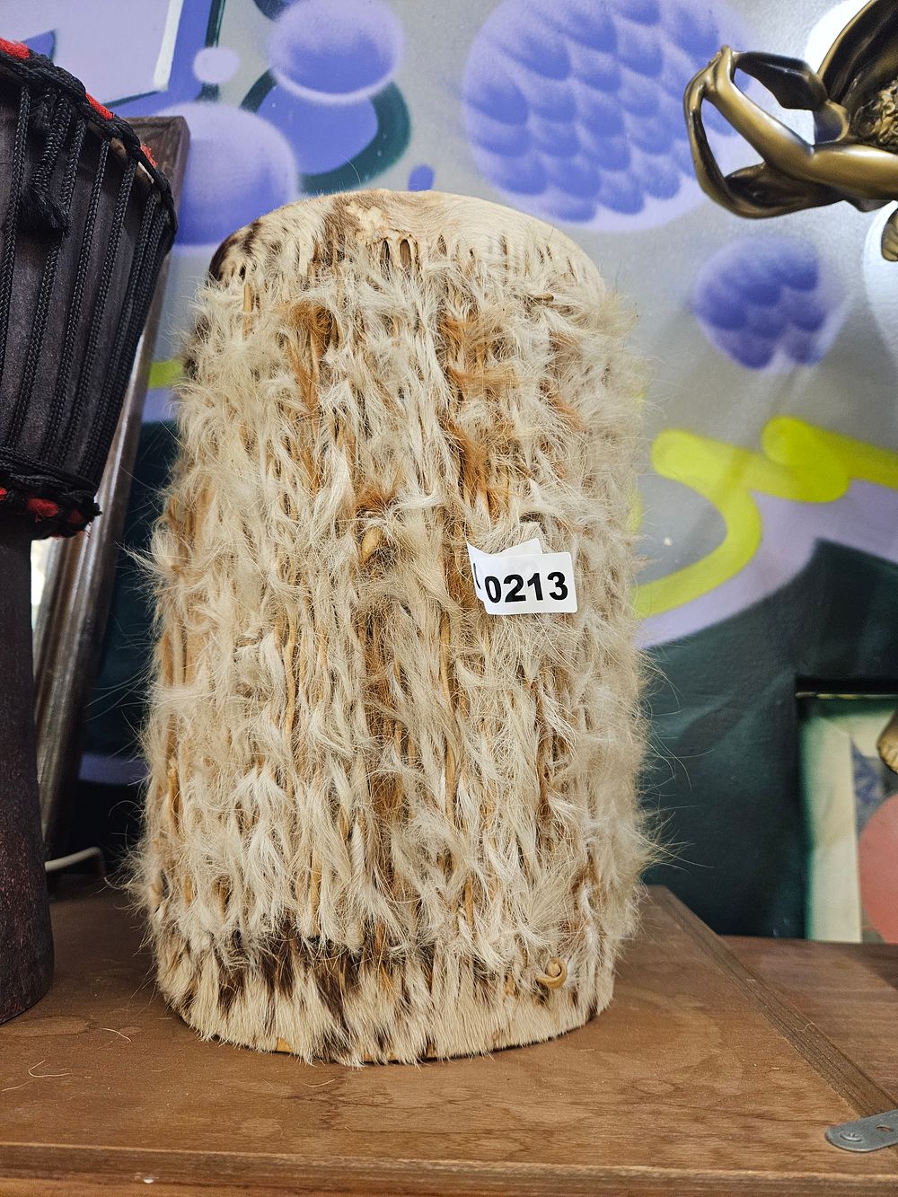 Lot 213 – A West African Style Animal Hide Cylindrical Hand Drum