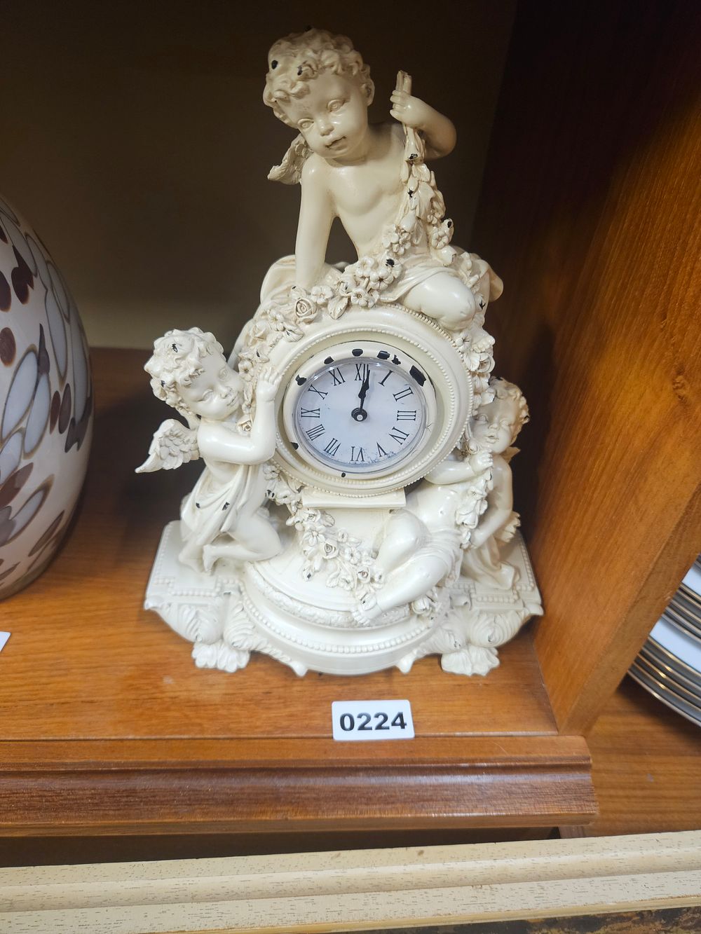 Lot 224 – A Rococo style composite figural cherub mantel clock