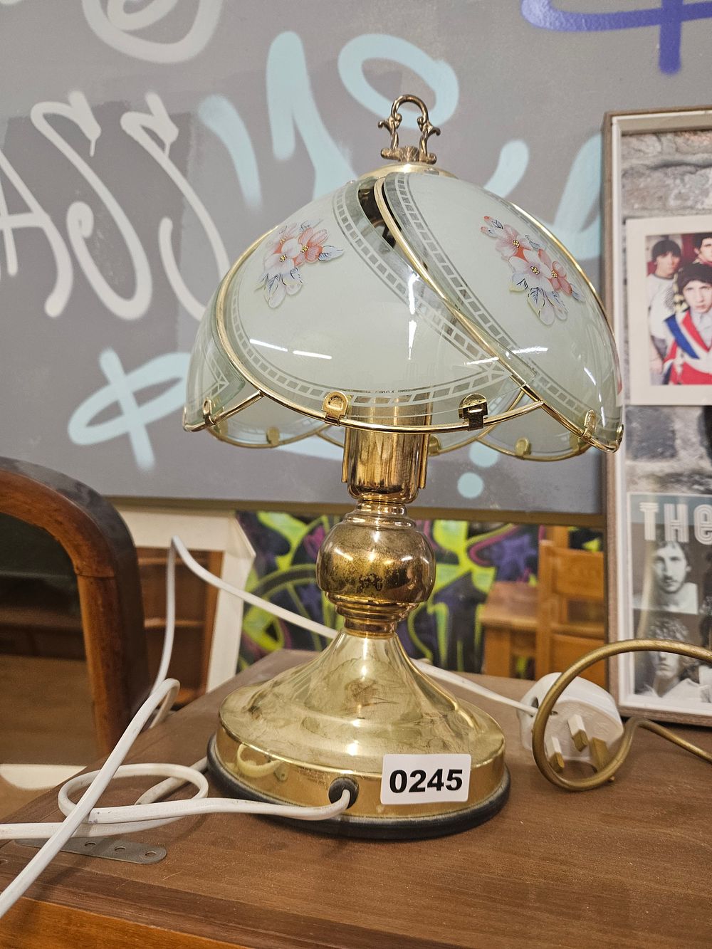 Lot 245 – A late 20th-century brass-toned metal touch lamp with floral glass shade panels