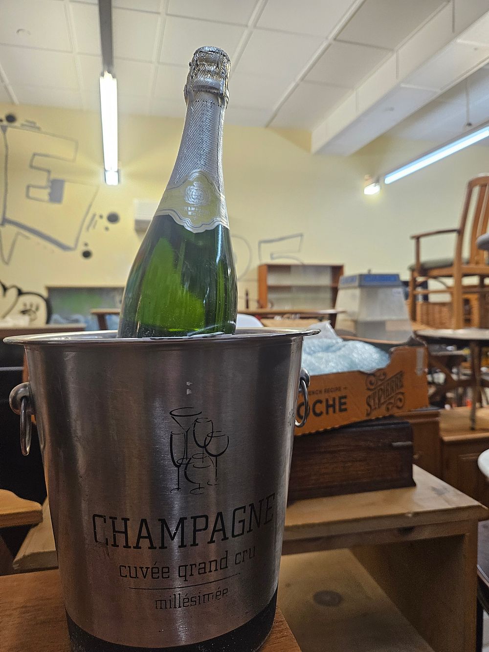 Lot 278 – A contemporary brushed stainless steel champagne ice bucket and bottle of champagne decorative