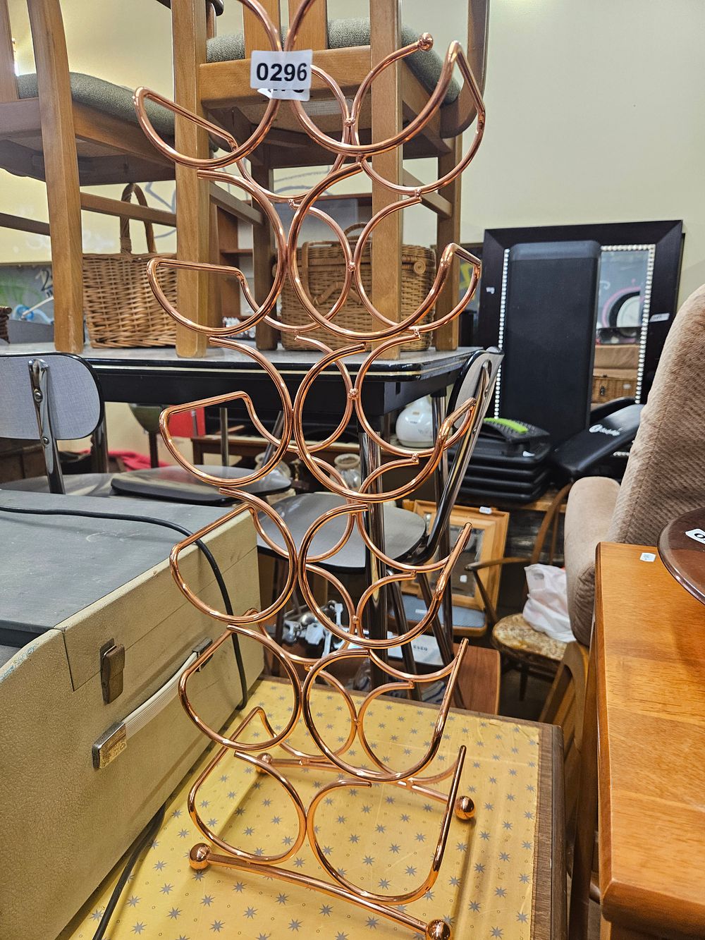 Lot 296 – A Contemporary Copper-Finish Six Bottle Metal Wine Rack