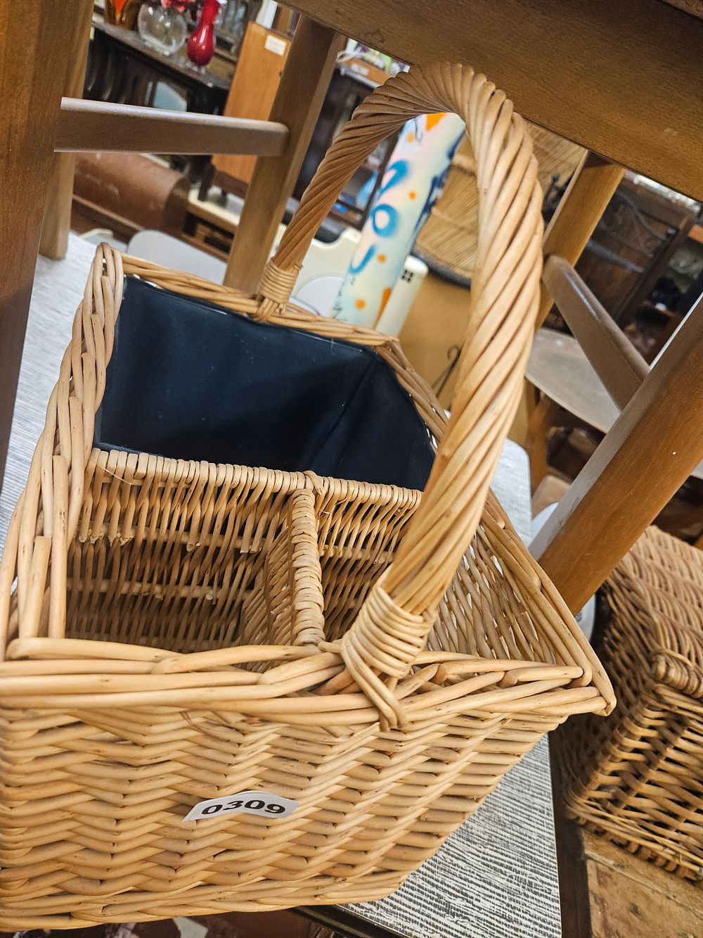 Lot 309 – A Woven Willow Utility Basket with Internal Dividers and Arched Handle