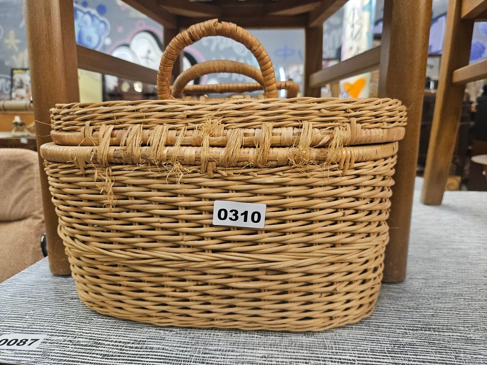 Lot 310 – An Oval Woven Wicker Storage Basket with Twin Handles