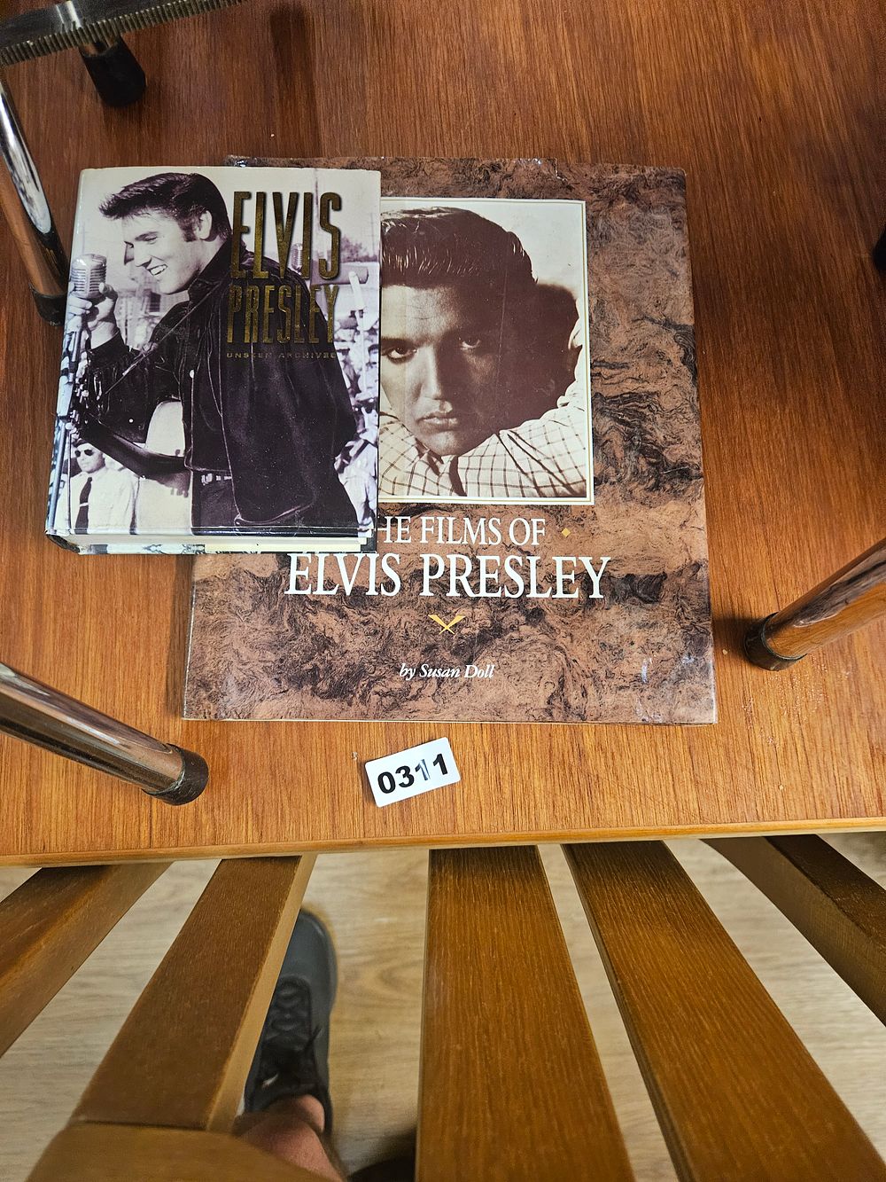 Lot 311 – A collection of Elvis Presley memorabilia comprising two books and a set of fridge magnets