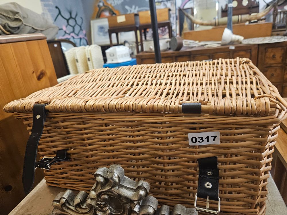 Lot 317 – A Woven Wicker Hamper with Leather Fastening Straps