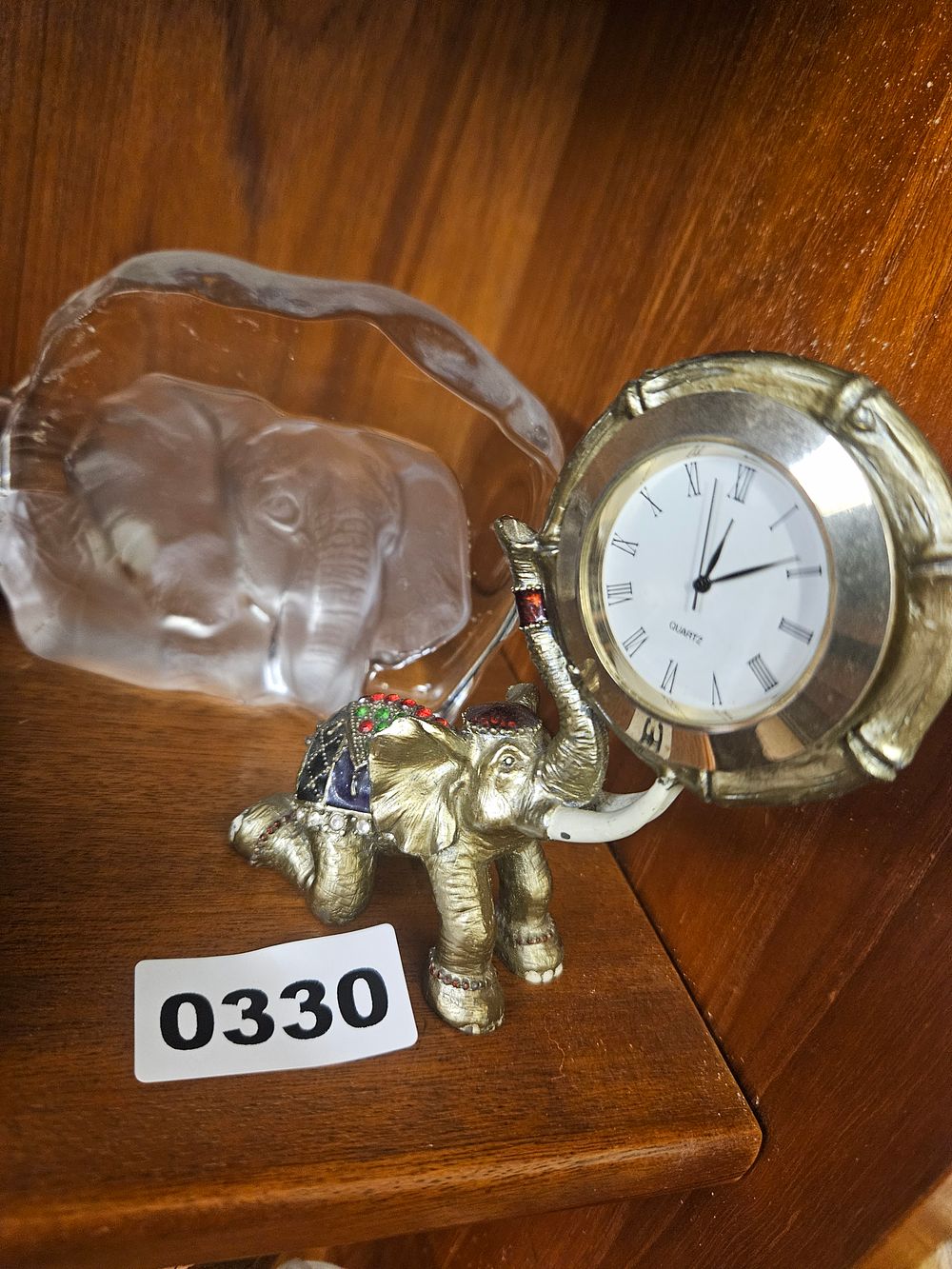 Lot 330 – Two decorative items including a novelty enamelled elephant quartz desk clock and an intaglio glass bowl