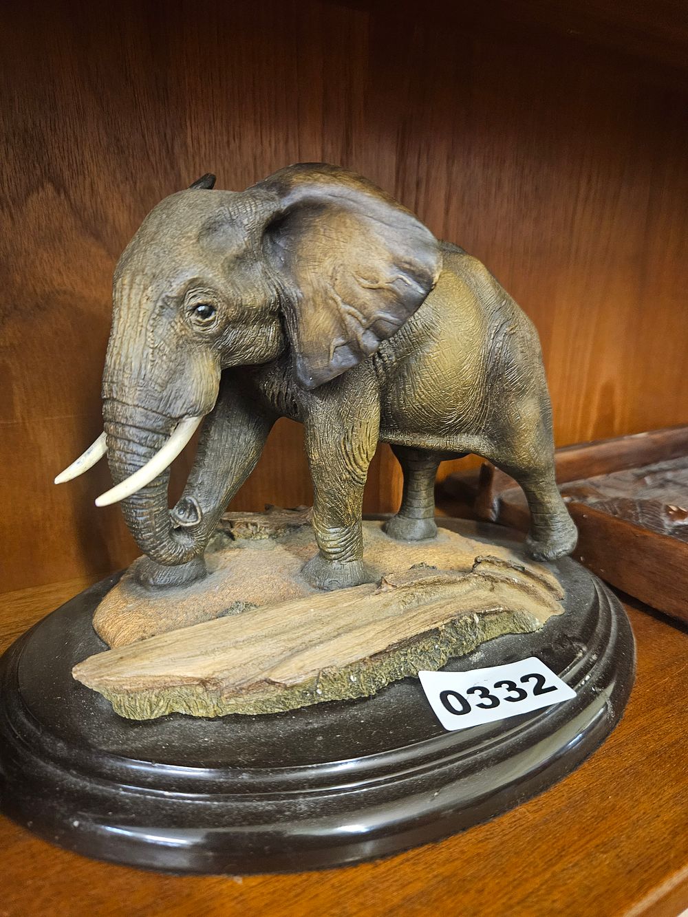 Lot 332 – A Detailed Cold-Cast Resin Sculpture of an African Elephant on a Circular Wooden Plinth